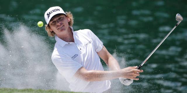 FILE - In this May 12, 2016, file photo, Will Wilcox hits from an 18th hole sand trap during the first round of The Players Championship golf tournament , in Ponte Vedra Beach, Fla. Wilcox is having a memorable debut at The Players Championship. He made a hole-in-one Friday, May 13, 2016, on the island-green 17th, one of the most famous par 3s in golf. (AP Photo/Chris O'Meara, File)
