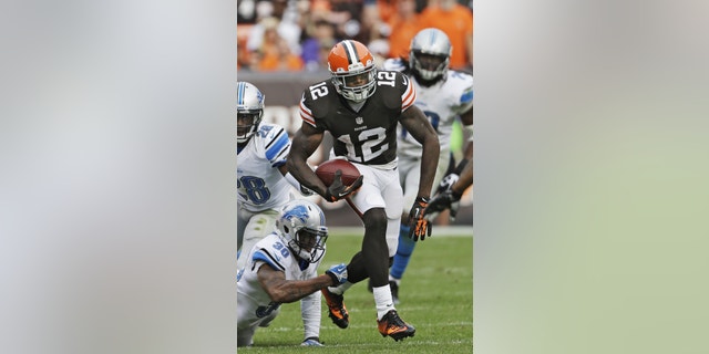 FILE - In this Sunday, Oct. 13, 2013, file photo, Cleveland Browns wide receiver Josh Gordon (12) breaks away from Detroit Lions defensive back Darius Slay (30) after a reception in the fourth quarter of an NFL football game in Cleveland. Gordon is tired of the trade rumors that have been whipping around him for weeks. With Tuesday's deadline approaching, Gordon could be down to his final days in Cleveland, where the front office insists it has not been shopping him to other teams. (AP Photo/Mark Duncan, File)