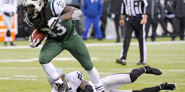 FILE - In this Dec. 8, 2013 file photo, New York Jets running back Chris Ivory (33) breaks away from Oakland Raiders safety Charles Woodson during the second half of an NFL football game, in East Rutherford, N.J. Ivory's carries the ball like a man possessed. (AP Photo/Bill Kostroun), File