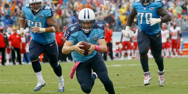 Tennessee Titans quarterback Ryan Fitzpatrick (4) dives into the end zone to score a touchdown on a 9-yard run against the Kansas City Chiefs in the fourth quarter of an NFL football game on Sunday, Oct. 6, 2013, in Nashville, Tenn. Titans linemen Rob Turner (59) and Chance Warmack (70) follow Fitzpatrick. (AP Photo/Wade Payne)