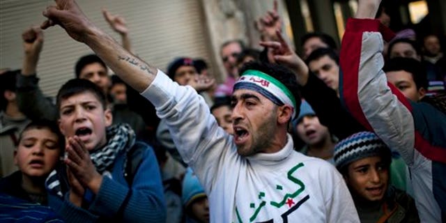 People chant slogans against Syrian President Bashar Al-Assad's regime during a demonstration in Kafar Taharim, northern Syria. (Associated Press)