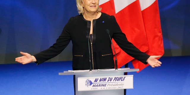 Far-right leader presidential candidate Marine Le Pen gestures as she speaks during a conference in Lyon, France, Sunday, Feb. 5, 2017. Marine Le Pen, the far-right presidential candidate, unveiled her platform Saturday at the start of a weekend conference, envisioning a thriving nation "made in France. (AP Photo/Michel Euler)