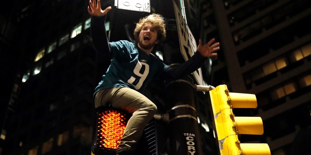 A Philadelphia Eagles fan celebrates the team's victory in the NFL Super Bowl 52 between the Philadelphia Eagles and the New England Patriots, Sunday, Feb. 4, 2018, in downtown Philadelphia.