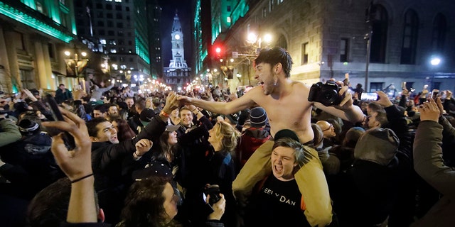 Philadelphia Eagles fans celebrate the team's victory in the NFL Super Bowl 52 between the Philadelphia Eagles and the New England Patriots, Sunday, Feb. 4, 2018, in downtown Philadelphia.