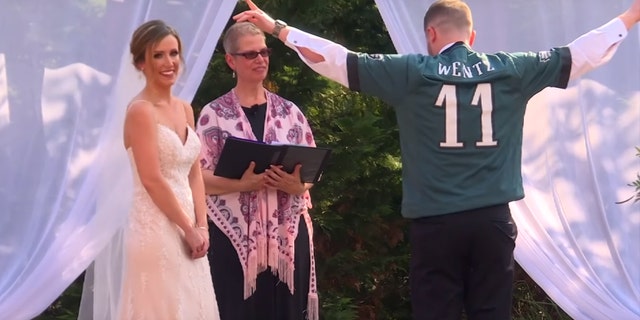 The crowd briefly cheered as Hanks donned the jersey — and the wedding DJ played the Eagles chant over the sound system.