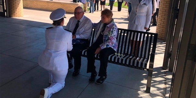A U.S. Navy officer presents the U.S. Flag presentation to his Wallace Eakes' nephew and next of kin, Gary Eakes.
