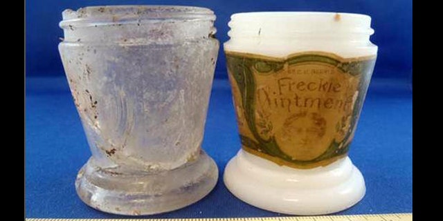 Glass fragments make up a nearly complete jar identical to the style used by Dr. C. H Berry's Freckle Ointment, a concoction marketed in the early 20th century that was supposed to make freckles fade (it was 11 percent mercury).