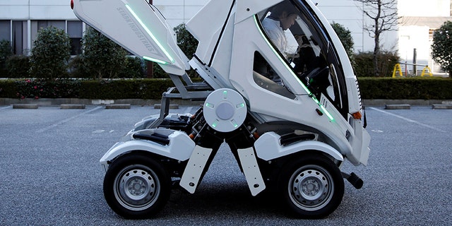 Four Link Systems, Inc's fully electric foldable vehicle 'Earth-1' which was designed by Kunio Okawara, famous in Japan as the artist behind the long-running wildly popular robot anime "Gundam", changes its form in Tokyo, Japan December 27, 2017. Picture taken December 27, 2017. REUTERS/Toru Hanai - RC149EA13170