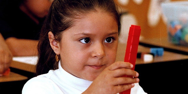 TYLER,TX - SEPTEMBER 11:  Seven-year-old Dulce Oliva constructs a stack of blocks during a math lesson in English at Birdwell Elementary School September 11, 2003 in Tyler, Texas. Oliva is one of the 60 percent of Hispanic students among a student body of 600 at the east Texas school.  (Photo by Mario Villafuerte/Getty Images)
