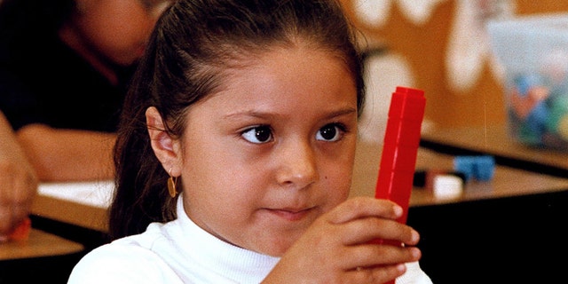 TYLER,TX - SEPTEMBER 11: Seven-year-old Dulce Oliva constructs a stack of blocks during a math lesson in English at Birdwell Elementary School September 11, 2003 in Tyler, Texas. Oliva is one of the 60 percent of Hispanic students among a student body of 600 at the east Texas school. (Photo by Mario Villafuerte/Getty Images)