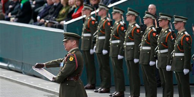 Captain Peter Kelleher from the 27th Infantry Battalion reads the Proclamation at the General Post Office on O'Connell street, Dublin, Ireland, Sunday, March, 27, 2016. (AP Photo/Peter Morrison)