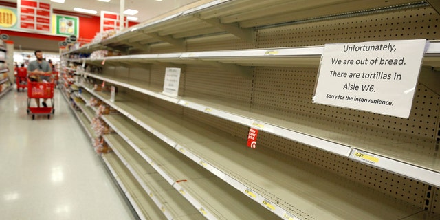 Shoppers encounter empty bread shelves ahead of the arrival of Hurricane Irma at a supermarket in Kissimmee, Florida, U.S. September 8, 2017. REUTERS/Gregg Newton - RC1A9B5359F0