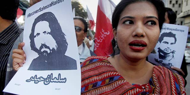 FILE - In this Tuesday, Jan. 10, 2017 file photo, a woman joins other demonstrators to condemn missing human rights activists, in Karachi, Pakistan. Pakistan banned Amir Liaqat, a TV host, over incitement and registered a criminal case against him Thursday, Jan. 26, 2017, after he called for five missing human rights activists and other liberal Pakistanis to be killed for blasphemy and sedition, officials said. The state media regulator said that Liaqat, a self-styled religious scholar, could no longer appear on the pro-military BOL TV, where he hosted a daily program, or any other local broadcast. (AP Photo/Fareed Khan, File)