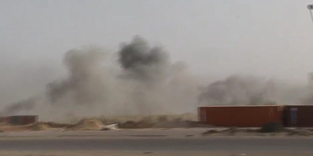 May 1: In this image taken from Associated Press Television News footage, smoke rises from the dock area of Misrata, Libya, after Libyan government forces fired more than two dozen Grad rockets and mortars towards the area. Misrata, which is the main rebel-held city in the west, has emerged as a key prize as the two sides have been locked in a stalemate with Qaddafi holding sway over the western half of the country and the rebels dominating the east. (AP/APTN)
