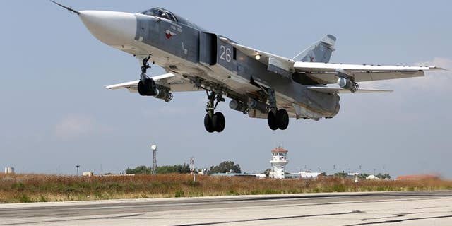 In this photo taken from Russian Defense Ministry official web site on Tuesday, Oct. 6, 2015, a Russian SU-24M jet fighter takes off from an airbase Hmeimim in Syria. A spokeswoman for the Russian foreign ministry has rejected claims that Russia in its airstrikes in Syria is targeting civilians or opposition forces. (Russian Defense Ministry Press Service via AP)