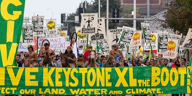 Demonstrators against the Keystone XL pipeline march in Lincoln, Neb.,  Aug. 6, 2017.