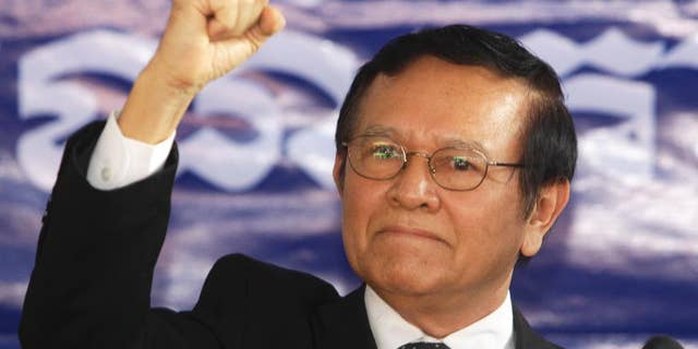 FILE - In This Friday, Sept. 9, 2016, file photo, opposition Cambodia National Rescue Party Deputy President Kem Sokha gestures during a speech at the party headquarters in Phnom Penh, Cambodia. Cambodia's King Norodom Sihamoni’s pardon Friday of Kem Sokha allows him to avoid five months in prison for failing to answer a summons in a case involving his alleged mistress. (AP Photo/Heng Sinith, File)