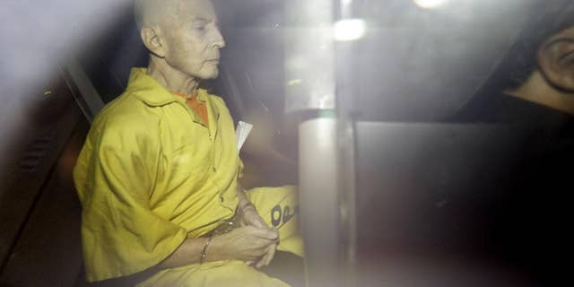 FILE -In this Tuesday, April 14, 2015 file photo, Robert Durst leaves Federal Court in an Orleans Parish Sheriff's vehicle after his arraignment, in New Orleans. An attorney for jailed real estate heir Robert Durst says Thursday, April 23, 2015, state weapon charges have been dropped against the millionaire, clearing the way for federal proceedings in New Orleans on similar charges. Durst, who faces a murder charge in an unrelated California case, remains jailed without bond in Louisiana. (AP Photo/Gerald Herbert, File)
