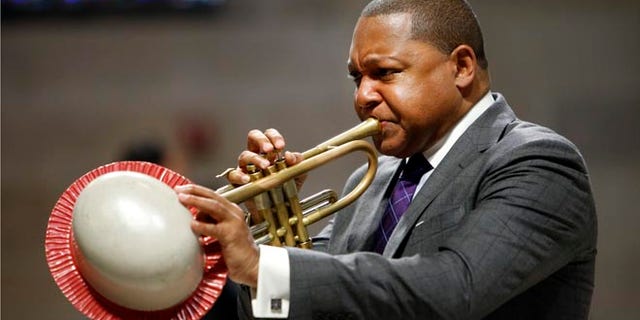 FILE - In this Sept. 20, 2014, file photo, musician Wynton Marsalis performs during a memorial service for actress Ruby Dee at The Riverside Church in New York. It was announced Wednesday, March 11, 2015, that Marsalis is scratching a concert in Venezuela amid rising tensions between Venezuela and the U.S. that are making it harder for U.S. citizens to travel to the South American country. (AP Photo/Jason DeCrow, File)