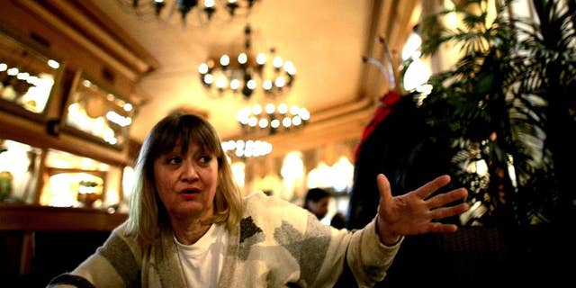 FILE-In this Friday, Feb. 15, 2008 file photo, Vesna Vulovic, an ex-air stewardess, and survivor of a fall from 10,000 meters when in 1972 her plane was blown up in mid-fight by a bomb, gestures as she gives an interview to the Associated Press in Belgrade, Serbia.   Serbia's state TV reports Saturday Dec. 24, 2016, Vulovic was found dead by her friends in her apartment in Belgrade, aged 66. (AP Photo/Marko Drobnjakovic)