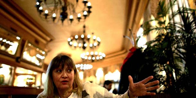 FILE-In this Friday, Feb. 15, 2008 file photo, Vesna Vulovic, an ex-air stewardess, and survivor of a fall from 10,000 meters when in 1972 her plane was blown up in mid-fight by a bomb, gestures as she gives an interview to the Associated Press in Belgrade, Serbia. Serbia's state TV reports Saturday Dec. 24, 2016, Vulovic was found dead by her friends in her apartment in Belgrade, aged 66. (AP Photo/Marko Drobnjakovic)