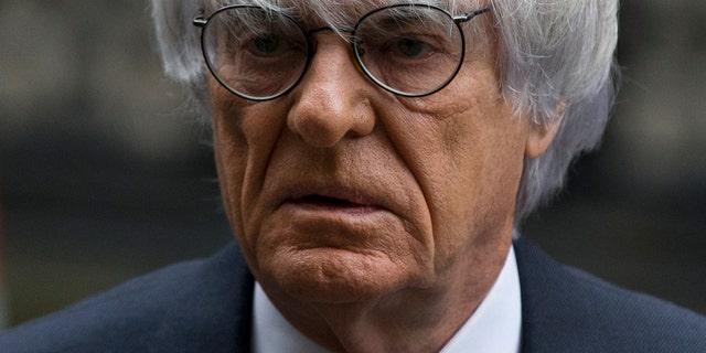 FILE - In this Nov. 11, 2013 file picture President and CEO of Formula One Management Bernie Ecclestone arrives for his case at the High Court in London. Formula 1 boss Bernie Ecclestone has won a multimillion-dollar case at London's High Court Thursday Feb. 20, 2014,relating to the sale of F1 in 2005 but the judge nevertheless said it was a corrupt deal. A former F1 shareholder, German media company Constantin Medien, had sued Ecclestone and other defendants for up to $144 million, claiming F1 was undervalued at the time of the sale to investment group CVC Capital Partners. (AP Photo/Matt Dunham. File)
