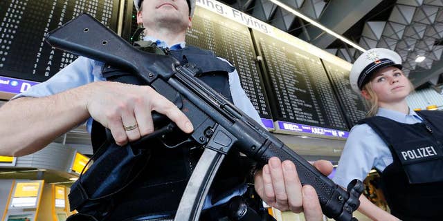 FILE - In this March 23, 2016 file photo, German police officers guard a terminal at the airport in Frankfurt, Germany, after security measures were increased after the Belgium attacks the previous day. The European Union unveiled plans on Wednesday, Nov. 16, 2016, for a new system of security checks on travelers permitted to enter Europe without visas in an effort to crack down on extremists. (AP Photo/Michael Probst, File)
