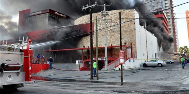 Smoke billows from the Casino Royale in Monterrey, Mexico, Thursday Aug. 25, 2011. Two dozen gunmen burst into the casino in northern Mexico on Thursday, doused it with a flammable liquid and started a fire that trapped gamblers inside, killing at least 32 people and injuring a dozen more, authorities said. (AP Photo)