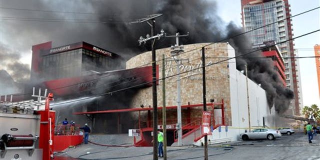 Smoke billows from the Casino Royale in Monterrey, Mexico, Thursday Aug. 25, 2011. Two dozen gunmen burst into the casino in northern Mexico on Thursday, doused it with a flammable liquid and started a fire that trapped gamblers inside, killing at least 32 people and injuring a dozen more, authorities said. (AP Photo)