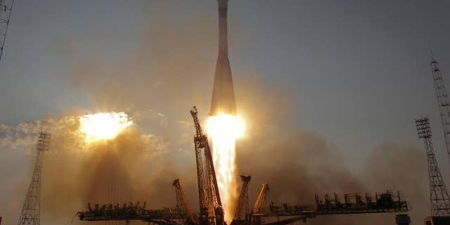 FILE - In this Thursday, July 7, 2016, file photo, the Soyuz-FG rocket booster with Soyuz MS space ship carrying a new crew to the International Space Station, ISS, blasts off at the Russian leased Baikonur cosmodrome, Kazakhstan. The capsule carrying astronauts from Russia, Japan and the United States has docked with the International Space Station Saturday after a two-day voyage. (AP Photo/Dmitri Lovetsky, File)