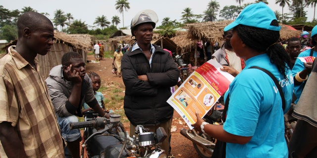 A UNICEF worker speaks with drivers of motorcycle taxis about the symptoms of Ebola virus disease (EVD) and best practices to help prevent its spread, in the city of Voinjama, in Lofa County, Liberia. REUTERS