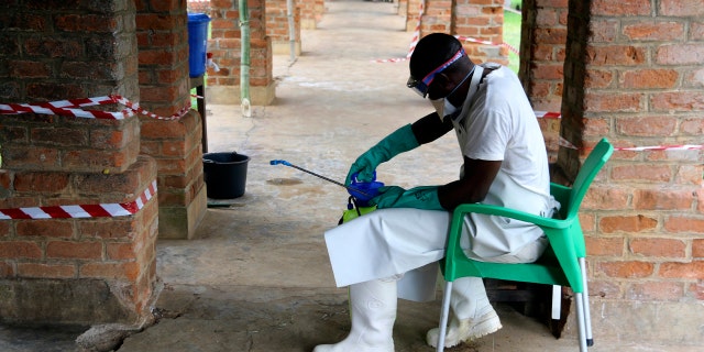 In this photo taken on Sunday, May 13, 2018, a health care worker wears virus protective gear at a treatment center in Bikoro Democratic Republic of Congo.