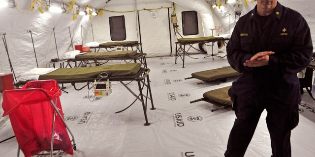 Nov. 5, 2014: In this file photo, on the outskirts of the city of Monrovia, Liberia, a health worker stands inside a medical tent that forms part of a new American clinic to be used for the treatment of people suffering from the Ebola virus.