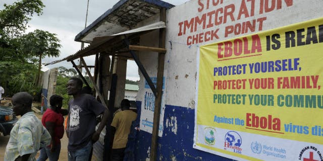 Liberian soldiers check people traveling in Bomi County August 11, 2014. (REUTERS/Stringer)