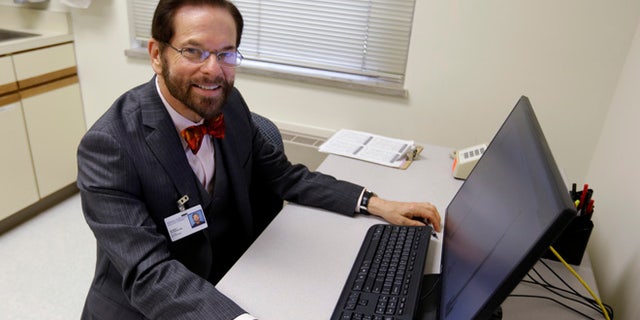 Aug 21, 2014: Dr. Robert Palinkas, director of the McKinley Health Center at the University of Illinois, poses in an exam room in Urbana, Ill. (AP)
