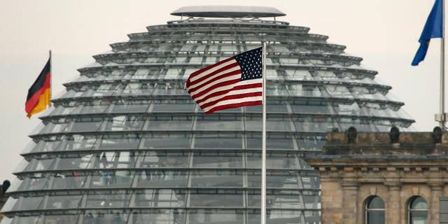 FILE - In this Oct. 25, 2013 file picture the US flag flies on top of the US embassy in front of the Reichstag building that houses the German Parliament, Bundestag, in Berlin, A German official says Chancellor Angela Merkel's chief of staff has asked the U.S. ambassador for a meeting to discuss the latest reports of alleged U.S. spying on Germany. The official says chief of staff Peter Altmaier invited Ambassador John B. Emerson to the chancellery Thursday July 2, 2015. (AP Photo/Michael Sohn,file)