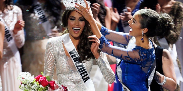 FILE - In this Nov. 9, 2013 file photo, Miss Universe 2012 Olivia Culpo, from the United States, right, places the crown on Miss Venezuela Gabriela Isler during the 2013 Miss Universe pageant in Moscow, Russia. Isler is scheduled to attend a news conference, Thursday, Oct. 2, 2014, along with pageant owner Donald Trump to announce the next Miss Universe pageant. (AP Photo/Pavel Golovkin, File)