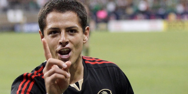 June 22: Mexico's Javier Hernandez gestures after scoring a goal against Honduras during overtime of a CONCACAF Gold Cup semifinal soccer match in Houston. (AP Photo/David J. Phillip)