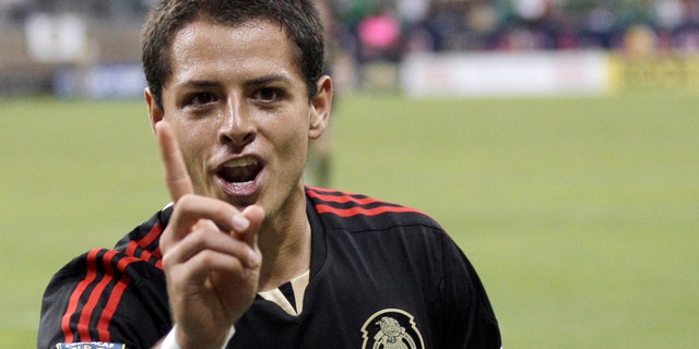 June 22: Mexico's Javier Hernandez gestures after scoring a goal against Honduras during overtime of a CONCACAF Gold Cup semifinal soccer match in Houston. (AP Photo/David J. Phillip)