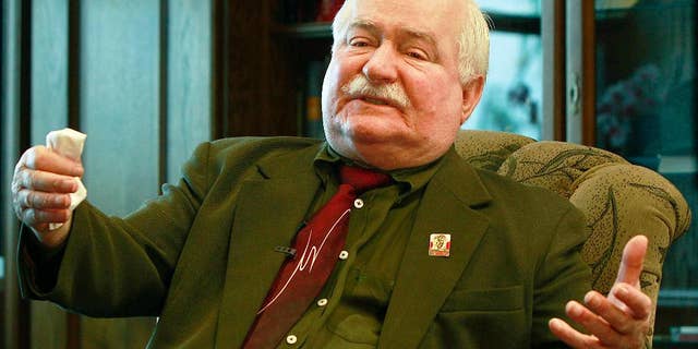 FILE- In this Wednesday, April 6, 2016 file photo, Poland’s former president and legendary Solidarity freedom movement founder Lech Walesa gestures during an exclusive interview with The Associated Press at his office at the European Solidarity Center in Gdansk, Poland. The son of former Polish president Lech Walesa said Thursday, Oct. 13, 2016, that his father, a longtime adversary of Poland's current leadership, is being stripped of state protection when he travels abroad. (AP Photo/Czarek Sokolowski, File)
