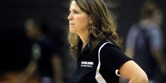 FILE - In this Oct. 16, 2012, file photo, Oakland University women's basketball coach Beckie Francis watches her team' practice in Rochester Hills, Mich. Oakland University says fired women’s basketball coach Francis physically and emotionally abused her players, was obsessed about their weight and pushed her Christian beliefs on them. The Detroit Free Press and The Oakland Press of Pontiac say the suburban Detroit-based public university made the statements in a brief responding to Francis’s suit in Oakland County Circuit Court. (AP Photo/Carlos Osorio, File)