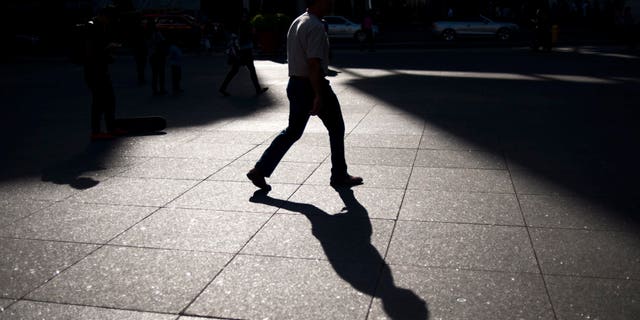 A person walks through Yonge and Dundas Square in Toronto, Friday, Sept, 25, 2015. (Marta Iwanek/The Canadian Press via AP) MANDATORY CREDIT