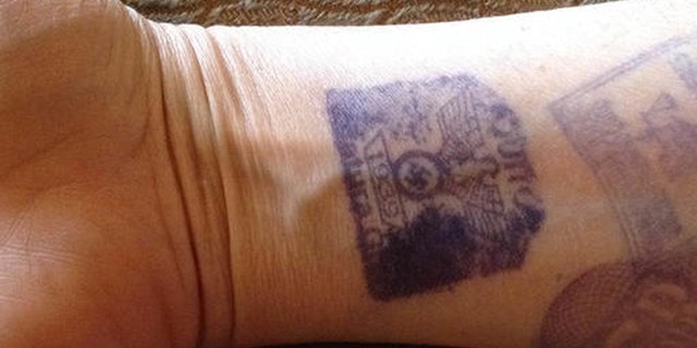 ALTERNATE CROP- In this Sept. 3, 2016, cell phone photo, provided by Maria Isabel Bonilla, shows her arm with prison visitors stamps, one featuring a Nazi Swastika, in Quito, Ecuador. Security guards at the prison were marking visitors with the stamps featuring the emblem of the Nazi Party with an eagle atop a Swastika and the year 1939. Bonilla who's husband is an inmate at the prison posted the photo on twitter causing an immediate uproar, with Ecuadors government immediately condemning the practice. (Maria Isabel Bonilla via AP)