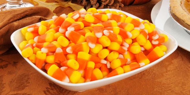 A bowl of candy corn with other Halloween or Thanksgiving treats