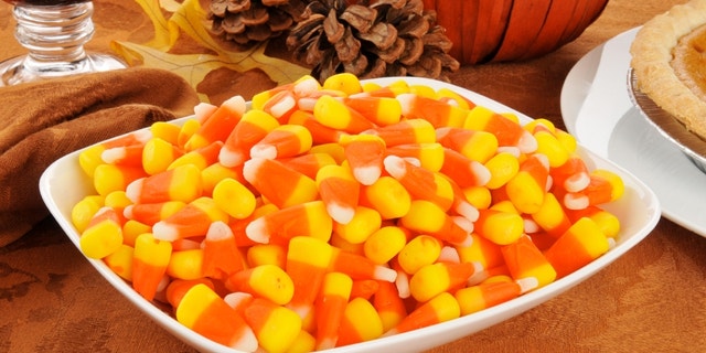 A bowl of candy corn with other Halloween or Thanksgiving treats