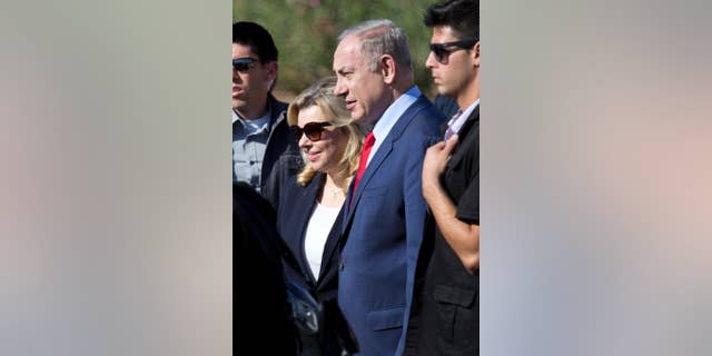 FILE -- In this Nov. 8, 2016 file photo, Israeli Prime Minister Benjamin Netanyahu, center, and his wife Sara attend an inauguration ceremony of the Hahemek rail line in the train station in Afula, Israel. Israeli media are reporting that police questioned the wife of Prime Minister Benjamin Netanyahu as part of the investigation into allegations that he improperly accepted gifts from wealthy supporters. Israel Radio and other media outlets reported Thursday, Jan. 12, 2017, that Sara Netanyahu was interviewed by police the night before. Police had no immediate comment. (AP Photo/Ariel Schalit, File)