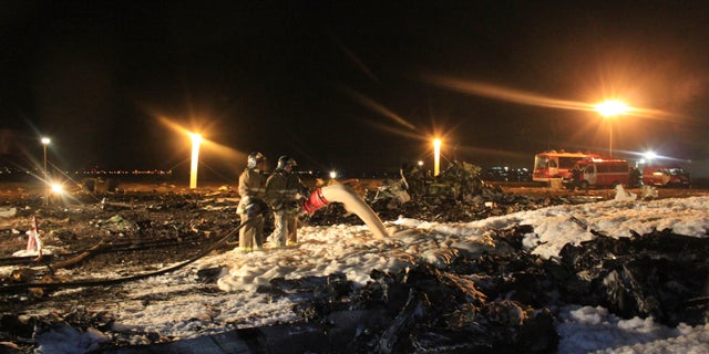 In this photo taken on Sunday, Nov. 17, 2013 and provided by Russian Emergency Situations Ministry fire fighters and rescuers work at the crash site of a Russian passenger airliner near Kazan, the capital of the Tatarstan republic, about 720 kilometers (450 miles) east of Moscow. A Russian passenger airliner crashed Sunday night while trying to land at the airport in the city of Kazan, killing all people aboard, officials said. The Boeing 737 belonging to Tatarstan Airlines crashed an hour after taking off from Moscow. There were no immediate indications of the cause. (AP Photo/Russian Emergency Situations Ministry)