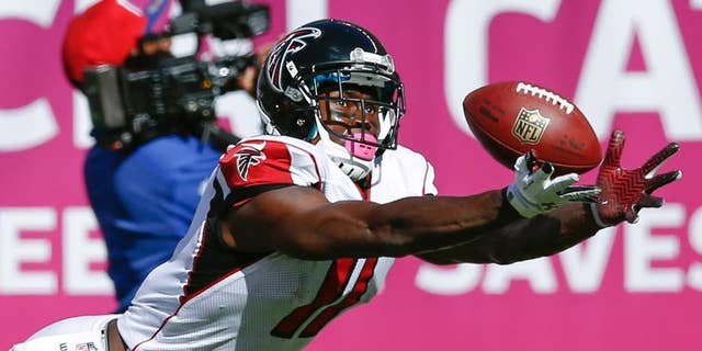 Atlanta Falcons wide receiver Julio Jones dives but is unable to catch a pass from quarterback Matt Ryan during the second half of an NFL football game against the New York Giants, Sunday, Oct. 5, 2014, in East Rutherford, N.J. (AP Photo/Kathy Willens)