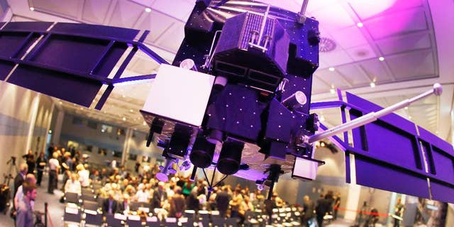 A model of orbiter Rosetta hangs from the ceiling in a conference room at the European Space Agency ESA in Darmstadt, Germany, Friday, Sept. 30, 2016. Rosetta will be impacted on comet 67P/Churyumov-Gerasimenko on Friday, marking the end of the twelve years lasting Rosetta mission. (AP Photo/Michael Probst)