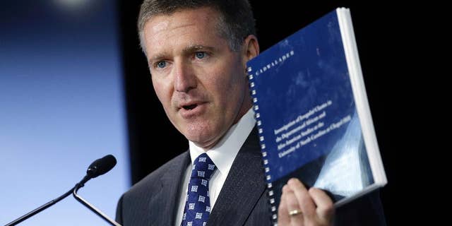 FILE - In this Oct. 22, 2014, file photo, Kenneth Wainstein, lead investigator into academic irregularities at the University of North Carolina at Chapel Hill, holds a copy of his findings following a special joint meeting of the University of North Carolina Board of Governors and the UNC-Chapel Hill Board of Trustees in Chapel Hill, N.C. The findings revealed academic fraud involving more than 3,100 students. North Carolina is scheduled to appear before an NCAA infractions committee panel Oct. 28 in the case tied to its long-running academic fraud scandal. (AP Photo/Gerry Broome, File0
